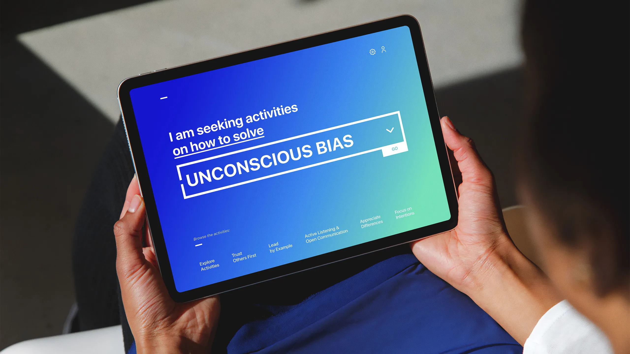 A woman holding a device installed with Facilitation Tool App