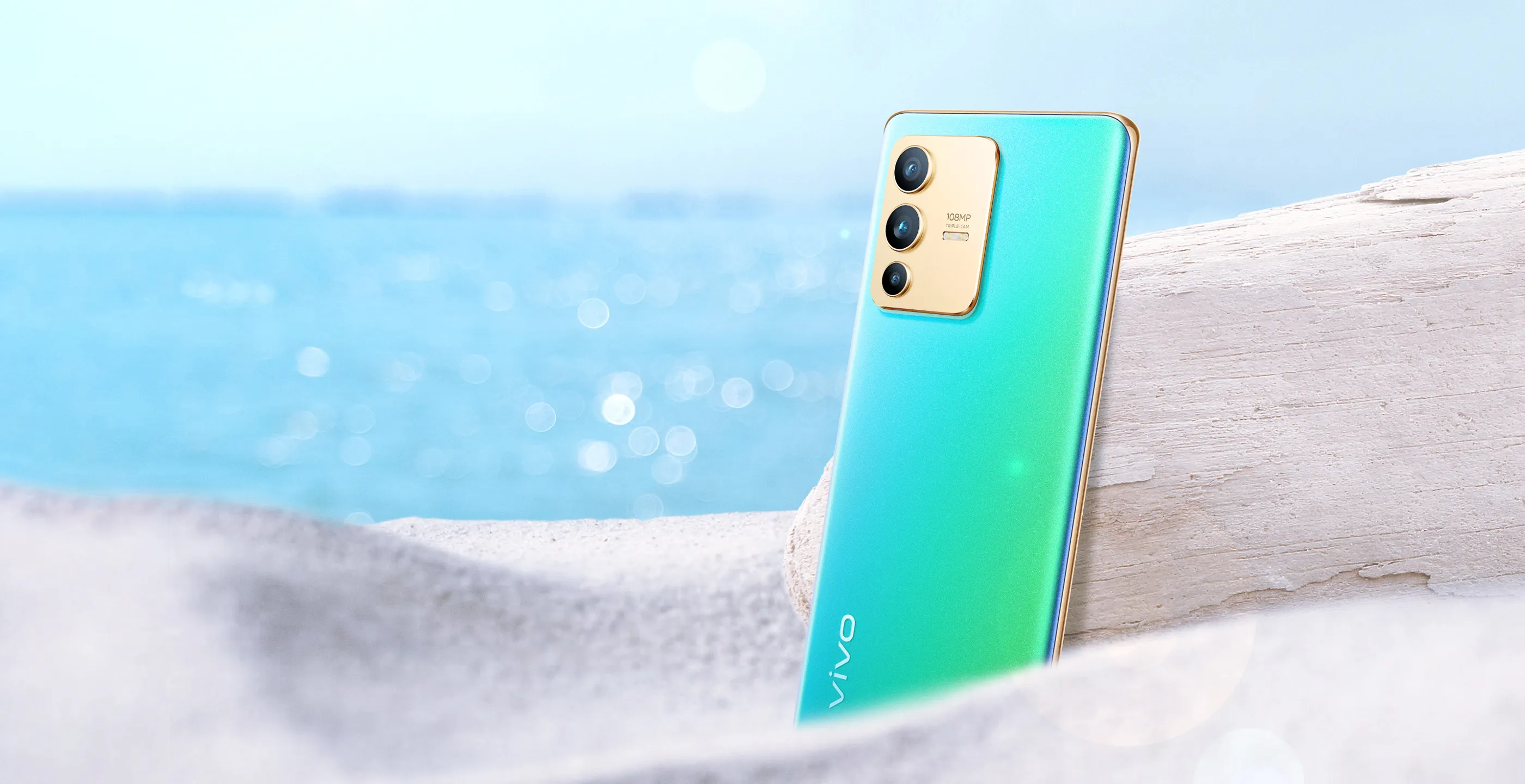 A phone lying on the sand sun bathing